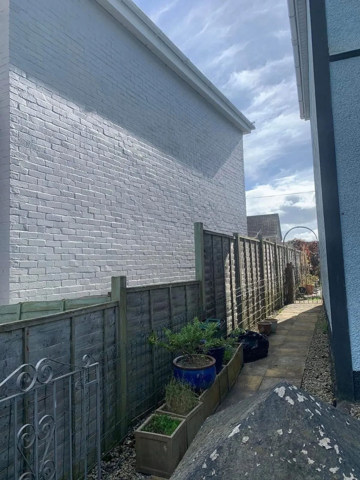 Freshly painted brick wall after preparation and masonry paint in St Austell